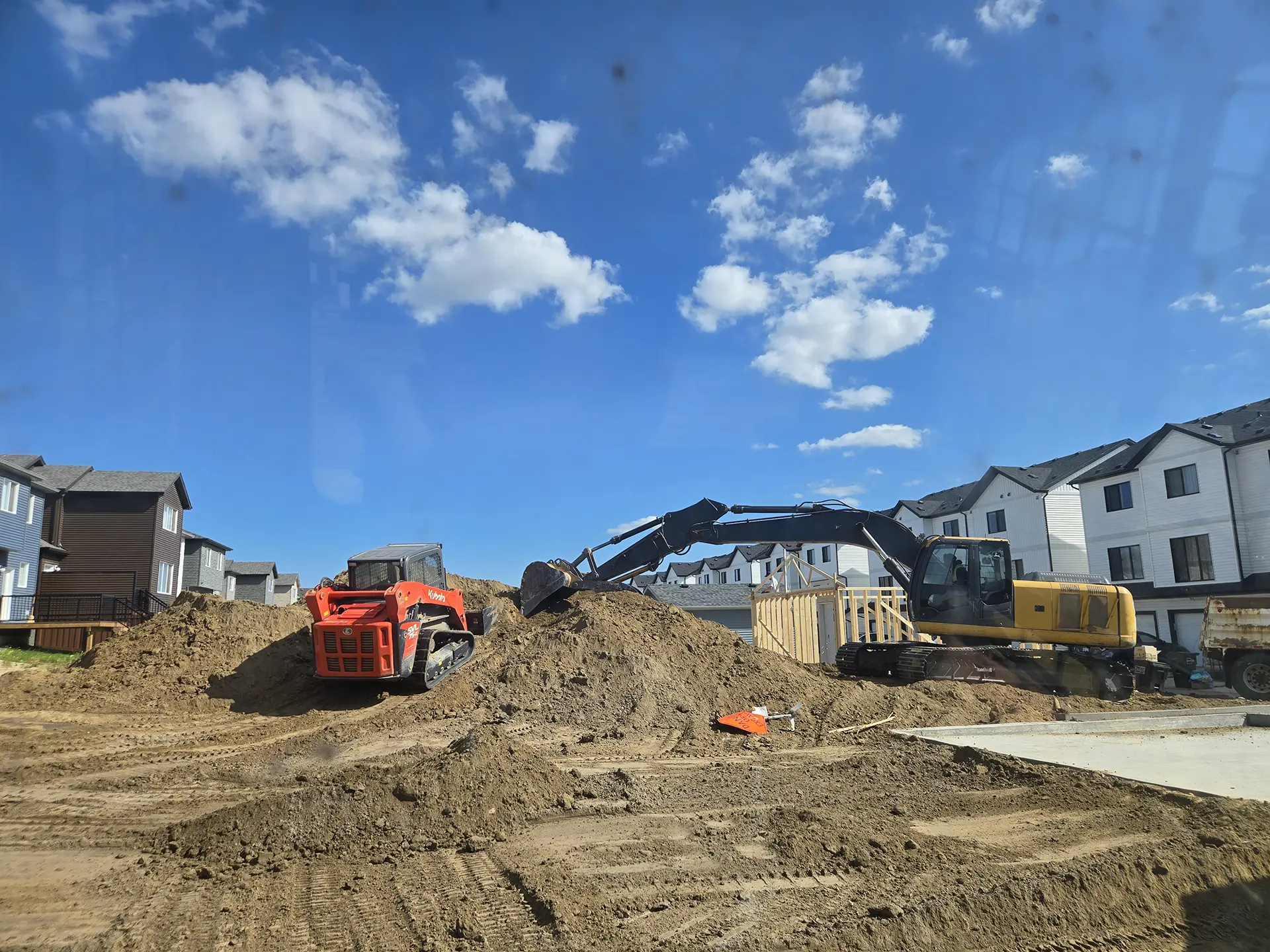 Moving clay during rough grading in Edmonton